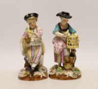A pair of John Bevington figures, late 19th century, both holding birds with floral encrusted bases,
