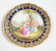 A Meissen-style rich blue and gilt bordered dish, the centre painted with a romantic scene with