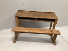 An early 20th century oak and pine child's desk with integral seat, width 120cm, depth 70cm,