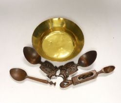 A small early brass bowl, together with a selection of four various treen spoons, bowl 20cm