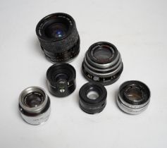 A collection of lenses for still cameras, including examples by Schneider-Kreuznach, Wray, Aldis,