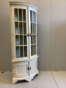 A reproduction George III style painted bow front standing corner cabinet, width 96cm, depth 58cm,