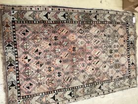 An antique Turkish faded red ground rug, 158 x 98cm