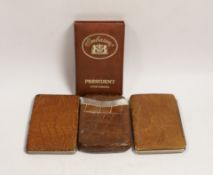 A silver-mounted leather cigar case and two others, together with a box of five Corona cigars.