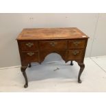 A Queen Anne revival feather banded walnut kneehole dressing table (front leg a/f), width 88cm,