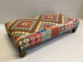 A rectangular Kilim footstool, on oak feet width 111cm, depth 60cm, height 25cm