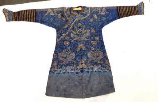 A Chinese fine blue gauze summer robe embroidered with a gold thread dragon highlighted by