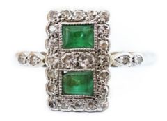 An Art Deco white metal, emerald and diamond set double cluster tablet ring, with diamondset