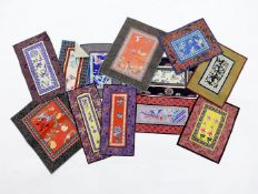 Twelve various Chinese rectangular silk polychrome embroidered mats with damask borders, of