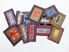 Twelve various Chinese rectangular silk polychrome embroidered mats with damask borders, of