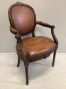 A Theodore Alexander mahogany and embossed tan leather elbow chair, width 61cm, depth 50cm, height