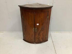 A George III mahogany bow front hanging corner cupboard, width 69cm, depth 48cm, height 90cm