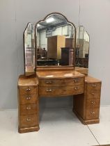 An Art Deco style burr walnut kneehole dressing table, width 136cm, depth 53cm, height 188cm