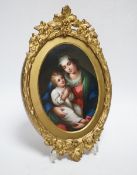 A 19th century Paris porcelain plaque depicting the Virgin Mother and child in a gilt painted frame,