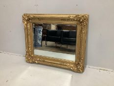 A Victorian style rectangular giltwood composition wall mirror (converted picture frame), width