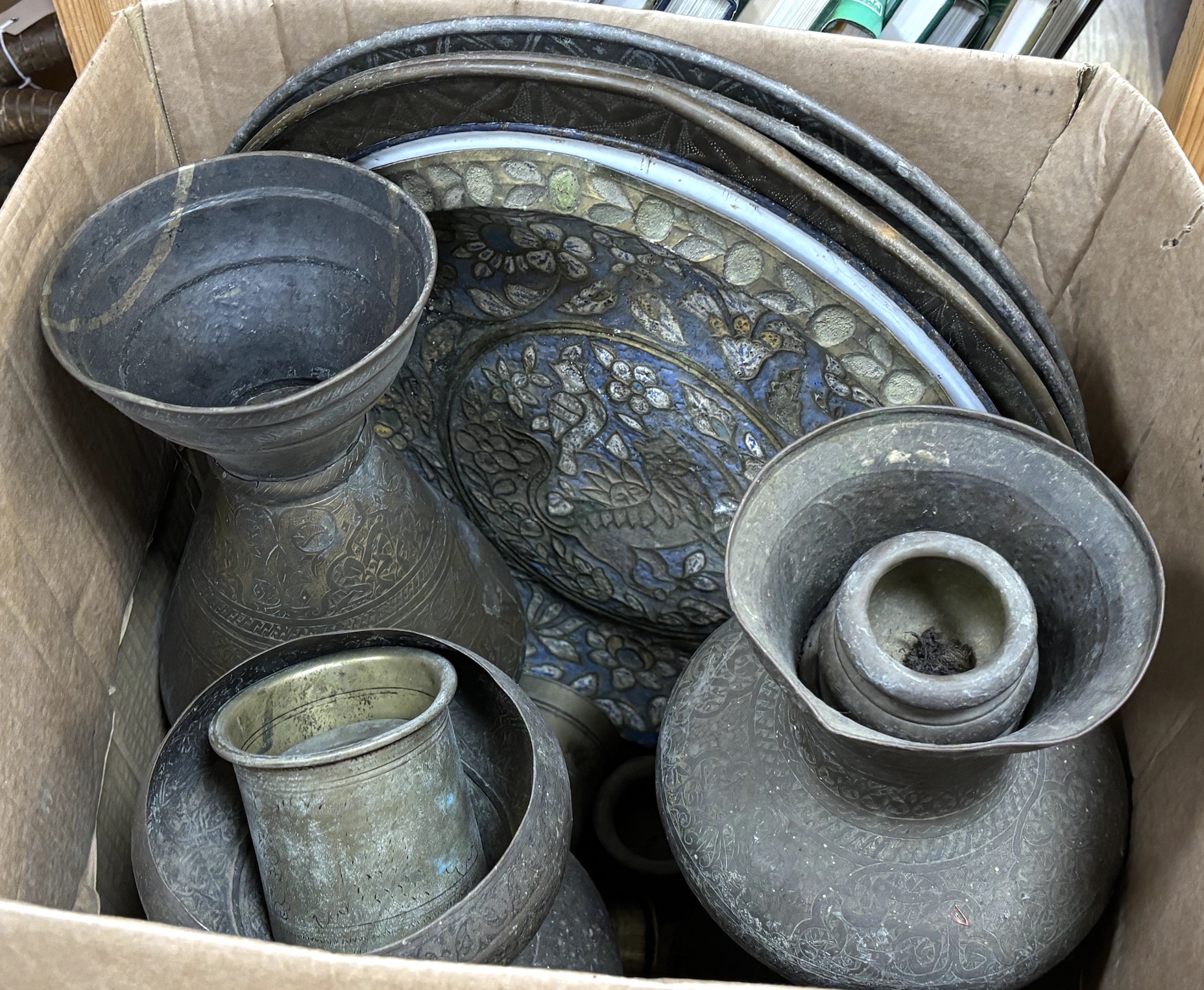 A collection of Indian metalware, including pots and measures, five trays, two vases, etc. tallest