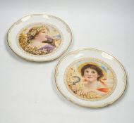 A pair of late 19th century Berlin plates, hand painted with females, 21.5cm