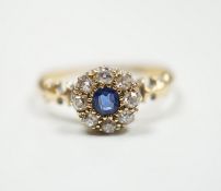 A late Victorian 18ct gold, sapphire and diamond set circular cluster ring, Birmingham, 1889, size