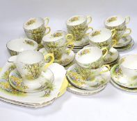 A Shelley ‘Daffodil Time’ pattern tea set with thirteen trios, sandwich plates, milk jug and bowl,