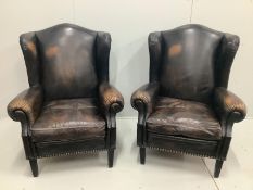 A pair of Victorian style brown leather wing armchairs, width 78cm, depth 88cm, height 106cm