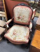 A pair of 19th century French rosewood open armchairs with floral needlepoint upholstery, width