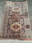 ** ** A Hamadan pink ground rug, the centre woven with a row of oval medallions, 185 x 70cms