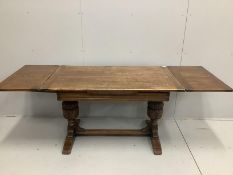 An 18th century style rectangular oak draw leaf dining table, length 210cm extended, width 77cm,