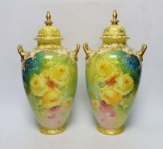 A pair of Royal Bonn flower painted earthenware vases and covers, 34cm