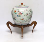 A 19th century Chinese famille verte jar and cover on associated wooden stand, vase 22cm