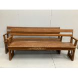 A pair of late 19th century Continental painted pine station benches with hinged adjustable backs,