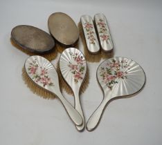 A George VI five piece silver and enamel mounted mirror and brush set, London, 1941 and a pair of