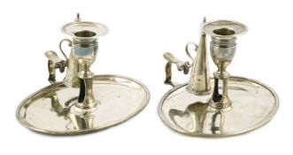 A pair of George III silver chambersticks, by Walter Brind, of oval form, with reeded border and