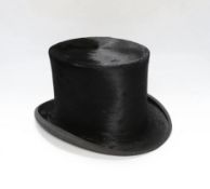 A brown leather case and top hat, hat box 24cm high