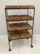 A wrought iron and pine four tier industrial trolley with eight printer's block trays, width 67cm,