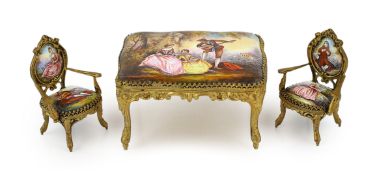 A 20th century Swiss enamel and ormolu musical miniature doll's house table with a pair of