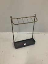 An Edwardian brass and cast iron five division stick stand, height 57cm together with four walking