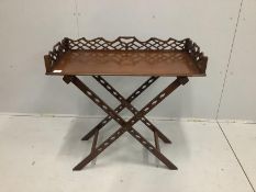 A reproduction George III style mahogany butler's tray on folding stand, width 84cm, depth 41cm,