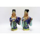 Two early 20th century Japanese enamelled porcelain figures of immortals, 27.5cm high