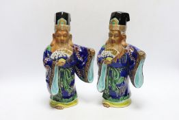Two early 20th century Japanese enamelled porcelain figures of immortals, 27.5cm high