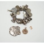 A silver charm bracelet, hung with assorted mainly white metal charms including tankard and Knight's