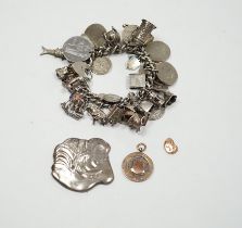 A silver charm bracelet, hung with assorted mainly white metal charms including tankard and Knight's