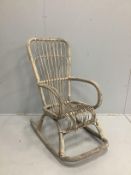 A vintage French bamboo and cane rocking elbow chair, width 54cm, depth 90cm, height 112cm