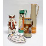 A Bisto jug, two other jugs, a Toby jug and a Quimper saucer, tallest 39cm