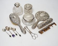 Seven assorted silver mounted glass scent bottles or toilet jars, and a repousse silver backed