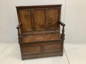 A small panelled oak box settle, width 96cm, depth 34cm, height 114cm