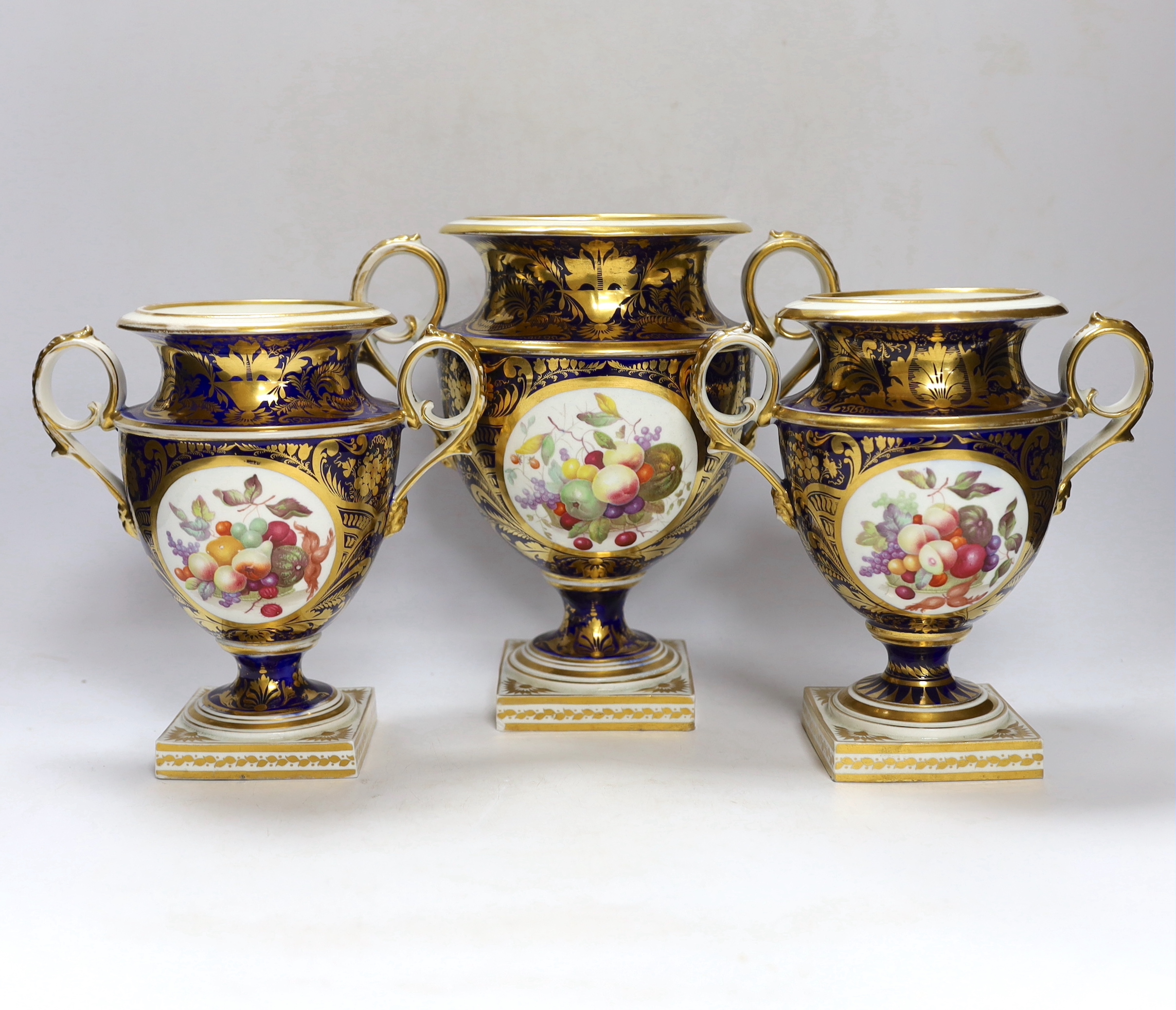 A garniture of three early 19th century Derby vases painted with fruit, tallest 23cm