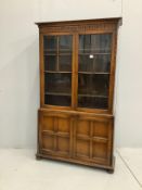 An early 20th century Jacobean revival oak bookcase, width 106cm, depth 31cm, height 183cm