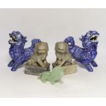 Two pairs of Chinese lion dogs; a blue and white porcelain set and a carved soapstone set,