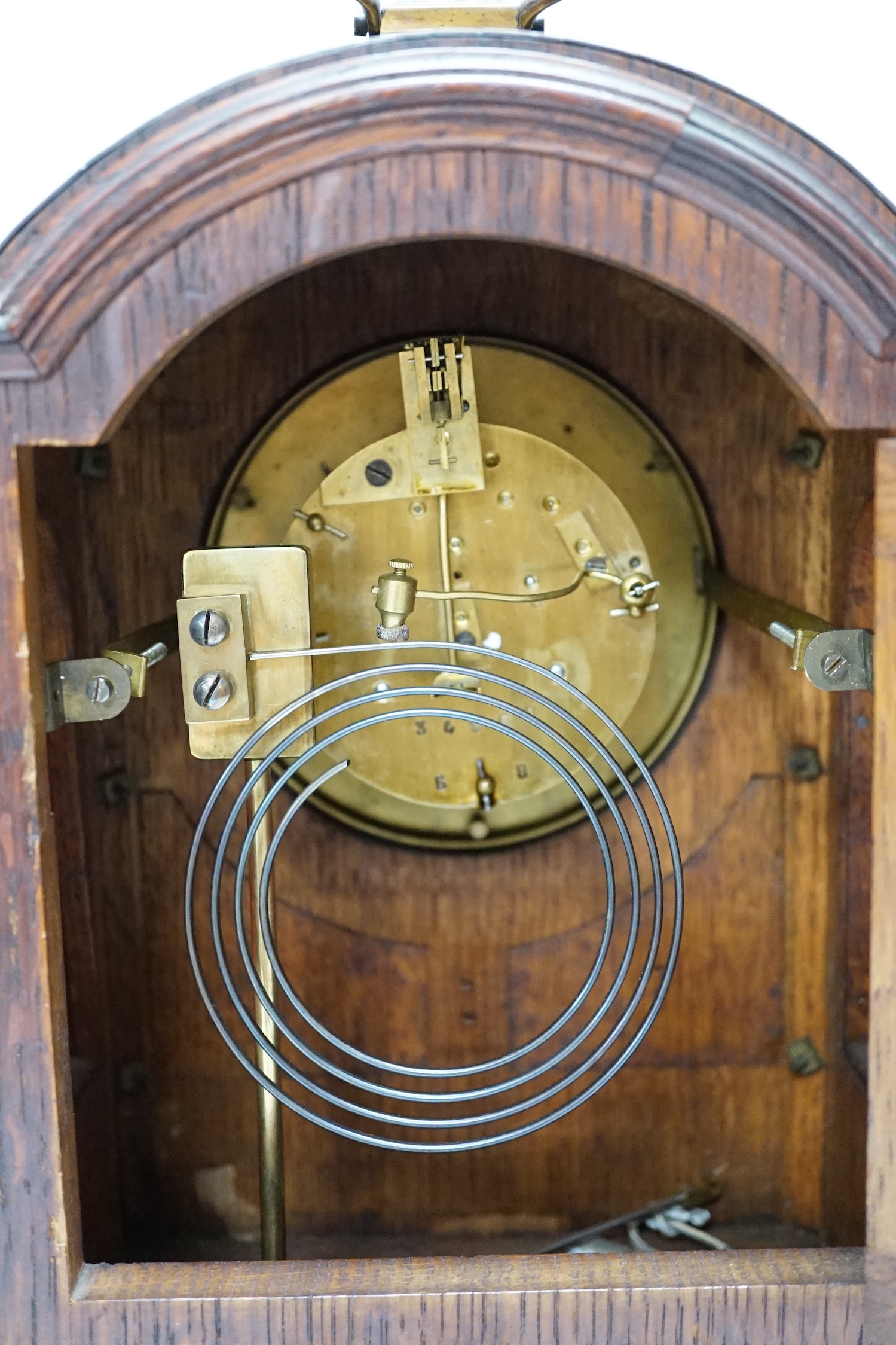 A oak mantel clock in a Regency style with pad top, striking on a coiled gong, 30cm high - Image 4 of 4