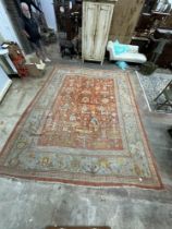 An Afghan red ground carpet, 395 x 310cm